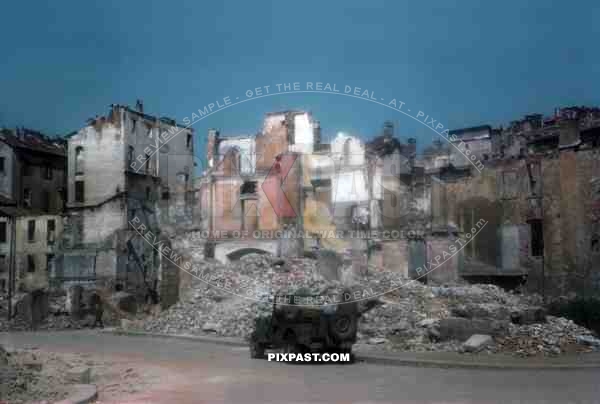 American army Willy Jeep of the 101st Cavalry Regiment enter destroyed Milan Italy 1945.