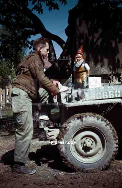 American soldier with german garden gnome. SS Childrens School in Buchenwald Germany 1945.