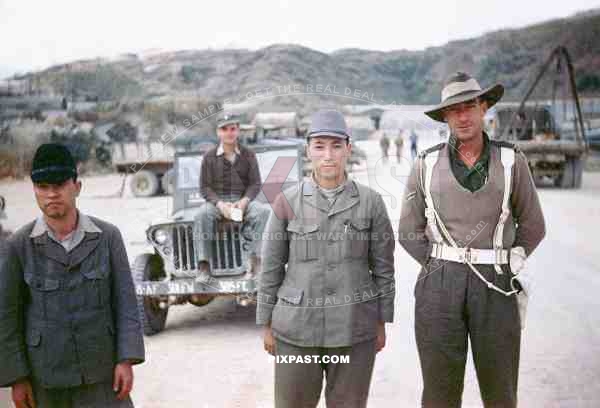 An Australian military police man escorting 2 captured Japanese POW soldiers in Sakishima 1945