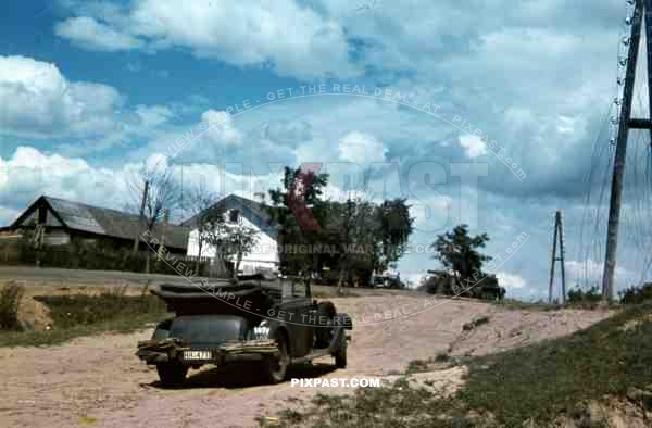 An der Rollbahn, Juli 1941, 94. Infantry Division, Russia. Staff Car and Half track with heavy artillery.