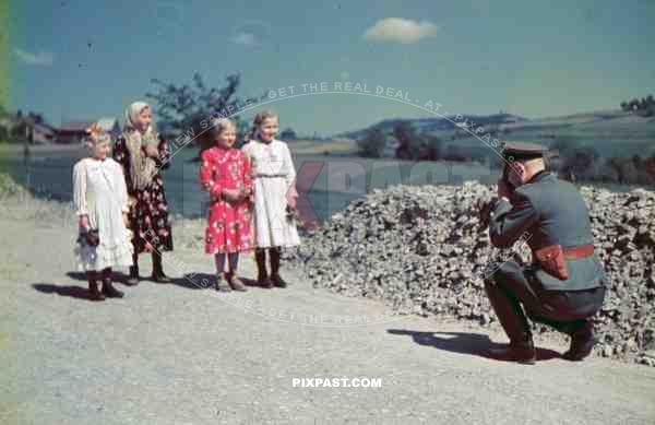 army cavalry officer photographing with camera children traditional costume Ukraine 1941 summer pistol holster