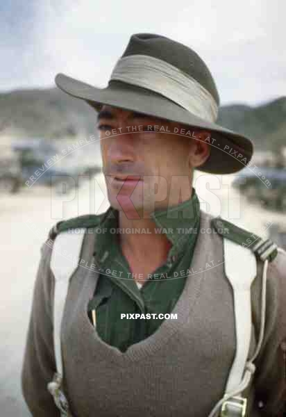 Australian Military Police man standing on the beaches of Sakishima 1945. Delivering some fresh Japanese POWs.