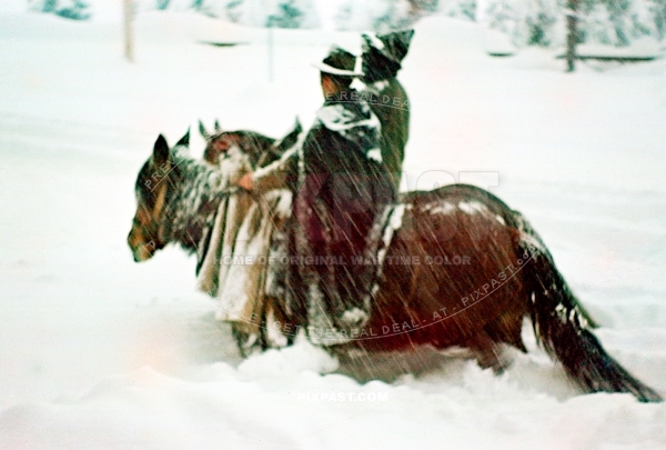 Austrian farmer man and wife riding horses in deep winter snow. In traditional rural costume. Austria winter 1939