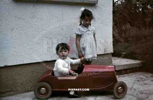 boy and girl playing with a toy car, Germany 1940