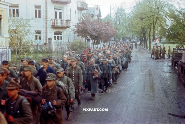 Captured German Luftwaffe soldiers walking through Murnau Bavaria Germany 1945. 101st Cavalry Regiment USA. POW