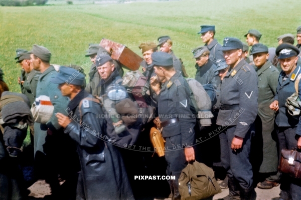 Captured German Luftwaffe soldiers walking through Murnau Bavaria Germany 1945. 101st Cavalry Regiment USA. POW