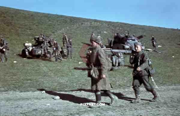 Captured Russian Prisoners of war walking past motor bike, Sd. Kfz. 247 Reconnaissance Armoured Car, Crimea 1942