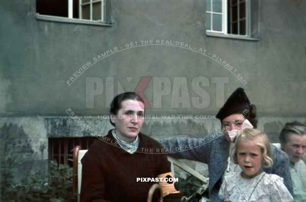 Family visiting a visually impaired relative. Women wears the yellow arm band for visually impaired. Munich Area 1940