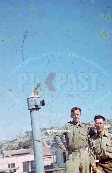 German Afrika Korp military in tropical uniform, on house roof, Tunisia, 1942. golden wounded badge, pocket watch.