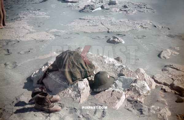 German Afrika Korp soldiers go swimming in the Mediterranean Sea after arriving in Libya 1941. Uniform laying on the beach