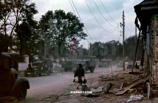 German army medical bus with transport trucks pass through captured Russian village. Russia 1941