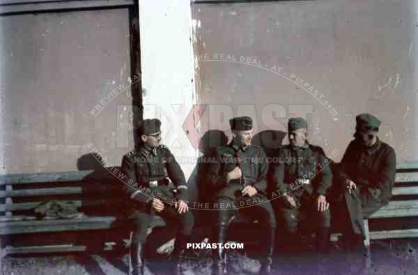 German army officers talk rest in Russian train station near Smolensk 1942. Ribbon bars, awards, arm bands.