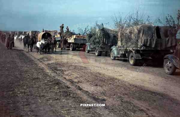 German army supply trucks retreat beside Romanian infantry unit, Russian Front 1944