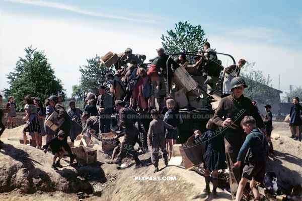 German children collecting rubbish from American truck. Worms Germany 1945