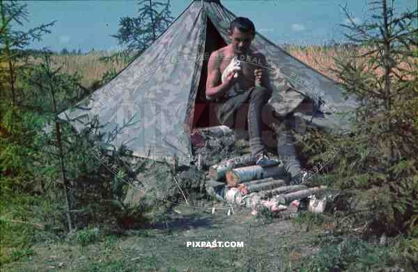 German Luftwaffe FLAK soldier cleaning tent Zeltbahn field russia summer 1941 3. Flak Abt. 701 