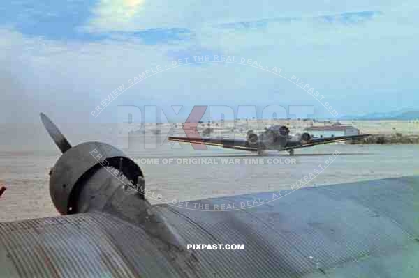 German Luftwaffe JU 52 Junkers transport plane landing in North Africa with telephone electrical supplies. 1943