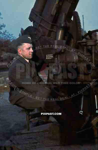 German Luftwaffe man sitting on Flak 88mm anti-aircraft gun, Bautzen, Saxony Germany 1943