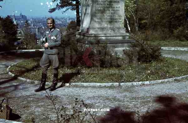 German Panzer Tank commander officer with medals stands beside WW1 memorial monument in Erfurt, Germany 1943