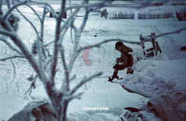 German soldier in helmet using toilet Russian front, winter 1943, 207th Infantry Division Wehrmacht