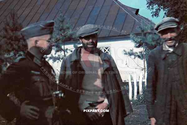 German soldier with Leica Camera talking to local Russian farmers. Russia 1942. 9th Panzer Division Kleist