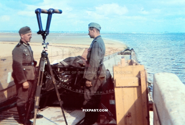 German soldiers beside army field binoculars and PAK-36 cannon. Coast of Normandy France 1940. 57 Infantry Division