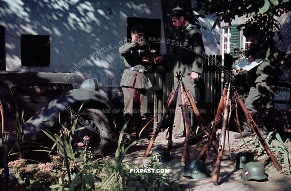 German soldiers drinking wine in the south of France 1940. KAR 98 rifles and M35 helmets. Staff car