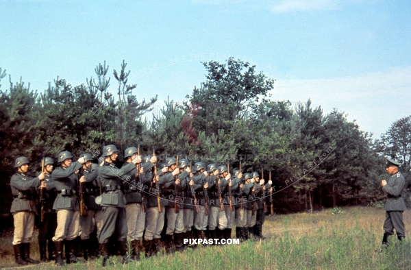 German Wehrmacht soldiers presenting arms Kar98 rifle in front of unit officer. France 1940