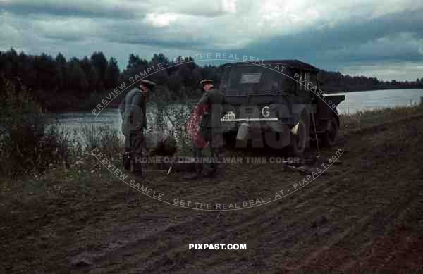 Horch 901, Medium staff car, Russian soldier repairing flat tyre. Charkow, 1942, 3rd Panzer Division.