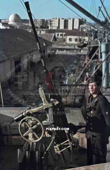 Kriegsmarine sailor beside 20mm Flak AA cannon on german supply ship, Tunis, Tunisia 1942, Quai Transatlantique