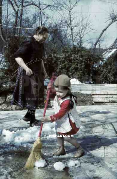 little girl sweeping the snow, Germany 1939