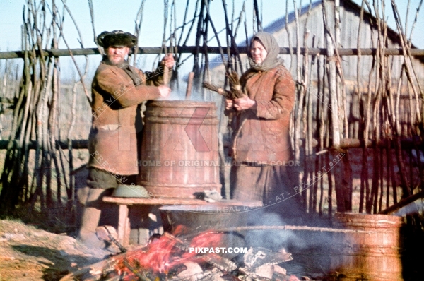 Local Russian farmers preparing warm soup over  an open fire  for their village on the outskirts of Smolensk Russia 1942