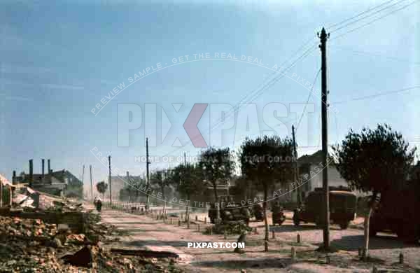 Main street in Ustiluh, Ukraine, Summer 1941, German 94. Infantry Division, Radio Funk Unit, staff car and trucks.