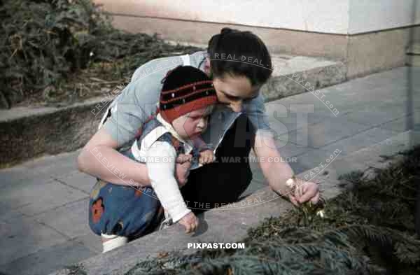 mother picking flowers with her little son, Germany 1939