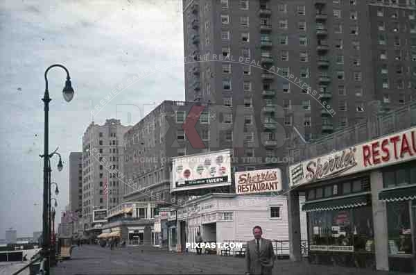 PostW color 1947 New York board walk shop restaurant american flag bank german tourist