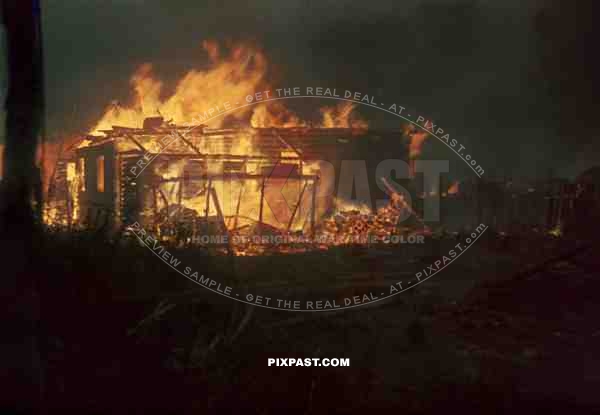 Russian village being burned to the ground for supporting Partisans. Near Rzhev Russia. Winter 1942.