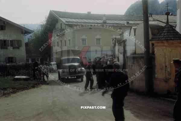 Surrendered German soldiers reading American Allied General Orders on wall in Kossen Austria 1945