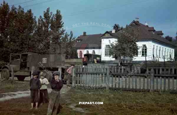 Tokari, Ukraine, 1941, Primary School. Children playing beside German army supply truck. 94. Infantry Division.