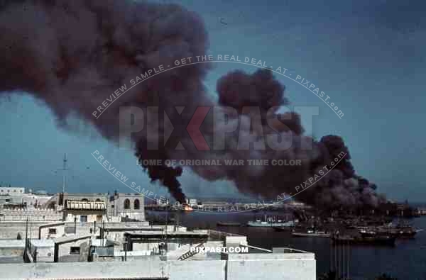 Tripoli harbour in Libya, 1942. Destroyed Burning german transport ships after Allied air attack.