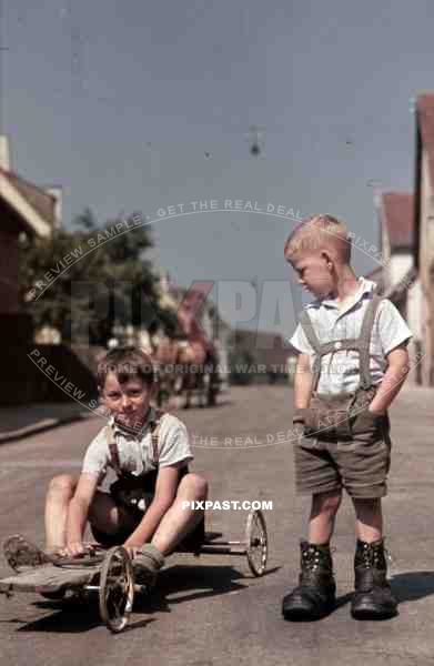 two boys with a selfmade kart on the road in Stuttgart, Germany ~1939