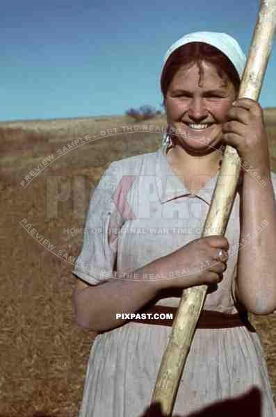 Ukrainian farmer girl in field talks and laughs with German panzer driver, Ukraine, 1941, 22nd Panzer Division.