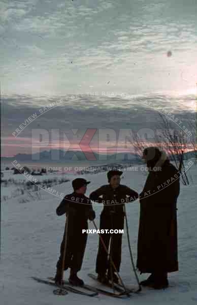 WW2 Color 2 Norwegian children on skies asking german soldier with helmet and kar98 rifle snow winter Norway 1940