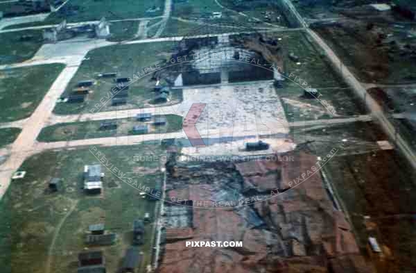 WW2 color Aerial view of bombed Belgium military airbase strip hangers 1940 german petrol trucks