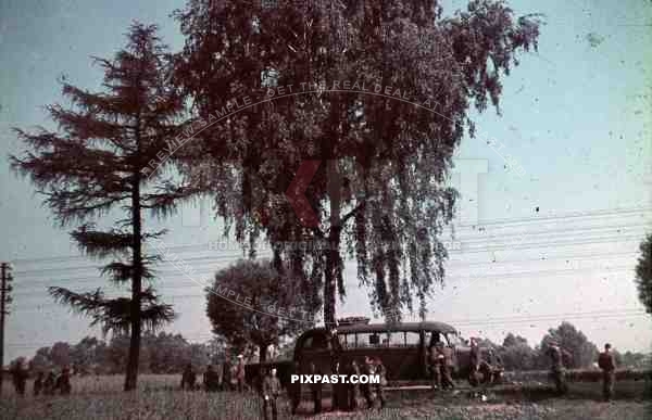 WW2 Color photo of German Military red cross ambulance bus in Poland battlefield with officers 1939 doctors