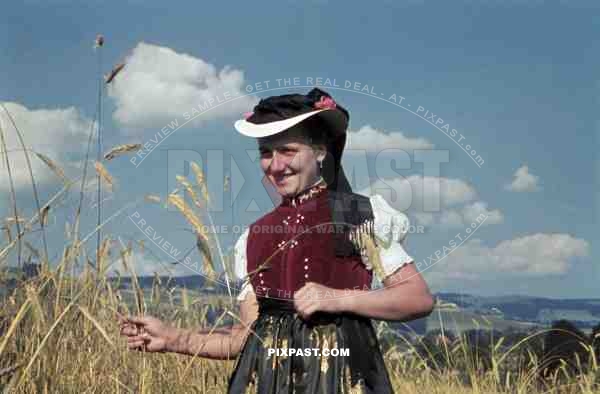 young woman in traditional costume in a field, Germany ~1938