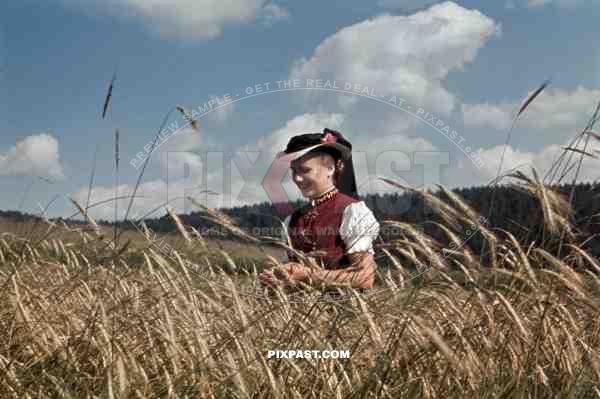 young woman in traditional costume in a field, Germany ~1938